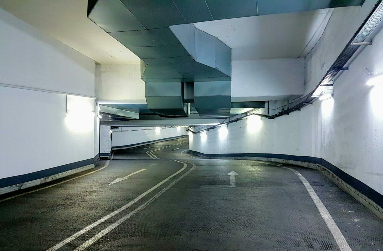 Home Interior view of a modern underground parking garage in Berlin, Germany. Well-lit and empty passage.